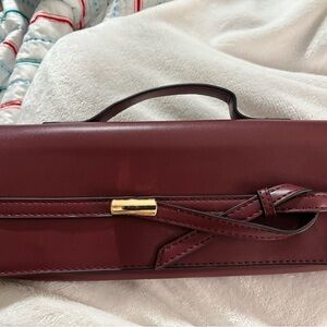 Bin: 3-9.     Chic Burgundy Clutch with Gold Detail